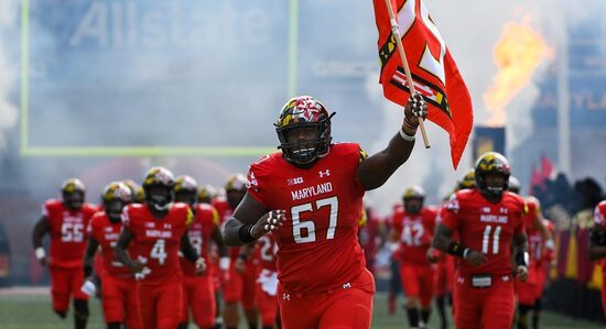 The UMD Football Team Comes Together to Kick a Booster Off a Plane